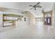 Bright and airy living room featuring an open floor plan with tile flooring and a breakfast bar at 1306 Pleasantridge Pl, Orlando, FL 32835