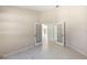 Empty room featuring tile floor, neutral walls, and French doors, offering a bright and flexible space at 1306 Pleasantridge Pl, Orlando, FL 32835