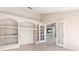 Versatile room with built-in shelving, double French doors, and tile flooring offers flexible living space at 1306 Pleasantridge Pl, Orlando, FL 32835