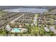 An elevated aerial view showcases the neighborhood's proximity to a lake and a community pool and playground at 14048 Lake Abbotts Dr, Winter Garden, FL 34787