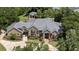 Luxury home with sprawling landscaped grounds, and a pool area visible in the background at 1500 Whitstable Ct, Lake Mary, FL 32746