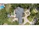 Aerial view of the house, pool, patio, and manicured grounds at 1500 Whitstable Ct, Lake Mary, FL 32746