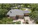 Expansive home with a tile roof and a brick driveway, surrounded by lush greenery and a private backyard pool at 1500 Whitstable Ct, Lake Mary, FL 32746