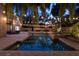 Gorgeous backyard featuring a sparkling pool, lush tropical landscaping, string lights, and cozy seating areas at 1500 Whitstable Ct, Lake Mary, FL 32746
