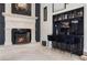 Wet bar with black and gold finishes, seating, and tiled floors at 1500 Whitstable Ct, Lake Mary, FL 32746