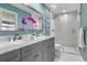Stylish bathroom featuring a double vanity with granite counters and a glass shower at 1500 Whitstable Ct, Lake Mary, FL 32746