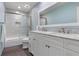 Bright bathroom with double vanity, white cabinets, and a shower over tub combination at 1500 Whitstable Ct, Lake Mary, FL 32746