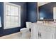 Charming bathroom with elegant vanity, marble countertop, and blue walls at 1500 Whitstable Ct, Lake Mary, FL 32746