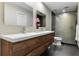 Modern bathroom with a wood vanity, double sinks, and glass-enclosed shower at 1500 Whitstable Ct, Lake Mary, FL 32746