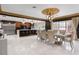 Bright dining area with large windows, decorative ceiling, and access to the modern kitchen at 1500 Whitstable Ct, Lake Mary, FL 32746