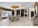 Open floorplan with dining table, fireplace, pillars, and elegant finishes at 1500 Whitstable Ct, Lake Mary, FL 32746