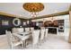 Open floorplan with dining table, kitchen, elegant lighting, and large mirror at 1500 Whitstable Ct, Lake Mary, FL 32746