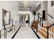 Impressive foyer featuring marble floors, high ceilings, elegant staircase, and stunning architectural details at 1500 Whitstable Ct, Lake Mary, FL 32746