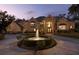 Stunning brick home with a circular driveway and a beautiful fountain feature in the front yard at 1500 Whitstable Ct, Lake Mary, FL 32746