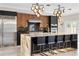 Spacious kitchen featuring an eat-in island, modern appliances, and black and wood cabinetry at 1500 Whitstable Ct, Lake Mary, FL 32746