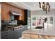 Close up on a chef's kitchen with stainless steel appliances and natural wood cabinetry at 1500 Whitstable Ct, Lake Mary, FL 32746