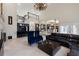 Grand living room with soaring ceilings, a staircase, and a stylish bar, providing an inviting and spacious area for relaxation at 1500 Whitstable Ct, Lake Mary, FL 32746