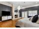 Primary suite featuring hardwood floors, fireplace, and large windows with natural light at 1500 Whitstable Ct, Lake Mary, FL 32746