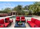 A backyard pool with multiple lounge areas and lush tropical landscaping at 1500 Whitstable Ct, Lake Mary, FL 32746