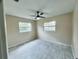 Bedroom featuring tile flooring, neutral walls, ceiling fan, and two windows at 1511 Leeway Ave, Orlando, FL 32810