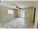 Bedroom featuring tile flooring, neutral walls, ceiling fan, and French doors leading to the yard at 1511 Leeway Ave, Orlando, FL 32810