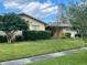 Charming single-story home with mature landscaping and a well-manicured lawn at 1511 Leeway Ave, Orlando, FL 32810