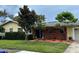 Beautiful single-story home showcasing a brick accent wall and colorful front garden at 1511 Leeway Ave, Orlando, FL 32810
