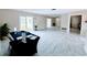 Spacious living room featuring tile floors, neutral walls, and natural light from sliding glass doors at 1511 Leeway Ave, Orlando, FL 32810