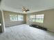 Spacious living room featuring tile flooring, neutral walls, large windows and a ceiling fan at 1511 Leeway Ave, Orlando, FL 32810