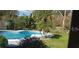 Inviting backyard pool surrounded by lush tropical landscaping for ultimate relaxation at 1511 Leeway Ave, Orlando, FL 32810