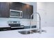 Close-up of a modern kitchen with stainless steel appliances and quartz countertops at 15401 Sw 65Th Terrace Rd, Ocala, FL 34473