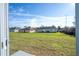 View of the backyard with a large grassy area, and neighboring homes in the distance at 15499 Sw 48Th Ave, Ocala, FL 34473
