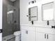 Modern bathroom featuring a dual sink vanity, a toilet, and a walk-in shower at 15499 Sw 48Th Ave, Ocala, FL 34473