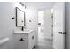 Bathroom featuring white cabinetry, quartz countertop, and a view into the kitchen at 15499 Sw 48Th Ave, Ocala, FL 34473