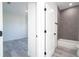 View from a bedroom into an adjoining bathroom featuring gray tiling and a bathtub at 15499 Sw 48Th Ave, Ocala, FL 34473