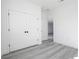 Bright bedroom with double closet, white doors, and luxury vinyl plank flooring at 15499 Sw 48Th Ave, Ocala, FL 34473