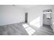 Primary bedroom with light hard surface flooring, a ceiling fan, and access to the bathroom at 15499 Sw 48Th Ave, Ocala, FL 34473