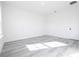 Sunny room with wood-look flooring and a fresh, neutral color scheme at 15499 Sw 48Th Ave, Ocala, FL 34473