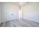 Bright bedroom featuring luxury vinyl plank flooring and a closet with double white doors at 15499 Sw 48Th Ave, Ocala, FL 34473