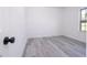 An empty bedroom with bright, white walls, luxury vinyl plank flooring, and a window providing natural light at 15499 Sw 48Th Ave, Ocala, FL 34473
