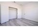 Bedroom with an open closet and gray wood-look flooring at 15499 Sw 48Th Ave, Ocala, FL 34473