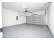 Spacious garage with an automatic door and gray painted concrete flooring at 15499 Sw 48Th Ave, Ocala, FL 34473