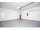 Garage interior with an automatic door, concrete floor, and water heater at 15499 Sw 48Th Ave, Ocala, FL 34473