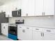 Close-up of kitchen showcasing quartz countertops and stainless steel appliances at 15499 Sw 48Th Ave, Ocala, FL 34473