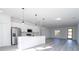 Open concept kitchen with stainless steel appliances and kitchen island overlooks the living area at 15499 Sw 48Th Ave, Ocala, FL 34473