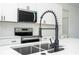 Close-up of kitchen sink with modern faucet and stainless steel appliances at 15499 Sw 48Th Ave, Ocala, FL 34473