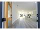 Bright living room with modern finishes, light wood flooring, and an open layout to kitchen at 15499 Sw 48Th Ave, Ocala, FL 34473