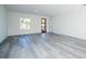 Bright living room featuring wood-style flooring, a window, and a wood door with glass panels at 15499 Sw 48Th Ave, Ocala, FL 34473