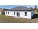 Rear exterior view of a single-story home with a gray roof and white exterior at 15499 Sw 48Th Ave, Ocala, FL 34473
