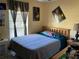 Bedroom featuring a comfortable bed, ceiling fan, and personalized decor at 1663 Sunburst Way, Kissimmee, FL 34744